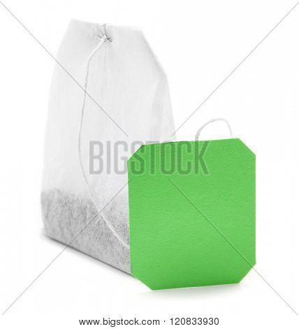 Teabag with green label isolated on white background
