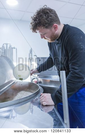 Man Adds Hops To A Beer Bucket