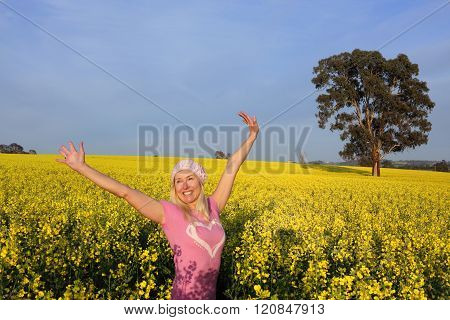 Happy Woman In Field Of Golden Canola