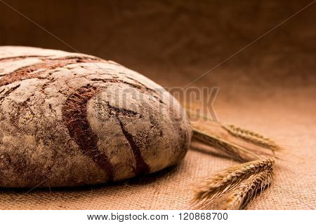 Rye Bread With Flour And Ears Of Wheat On The Table