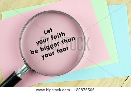 Magnifying glass on papers with inspirational words