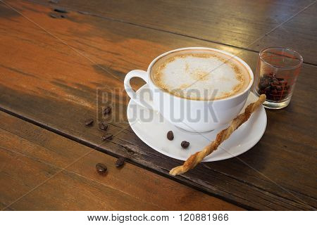 Hot Coffee And Coffee Bean On Wooden Table And Twisted Sweet Stick Biscuit/hot Coffee And Coffee Bea