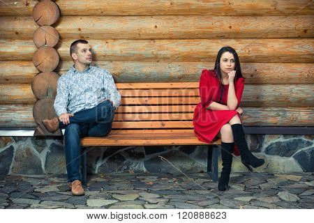 Young couple sitting apart on the bench