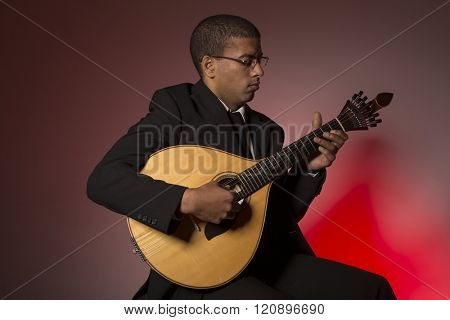 fado musician with a portuguese guitar, studio