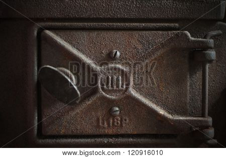 Old fashioned wood burning oven. Detail of the furnace - furnace door.