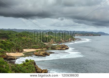 Rocky Pulau Jumpino island at Pantai Kukup beach in Java, Indonesia