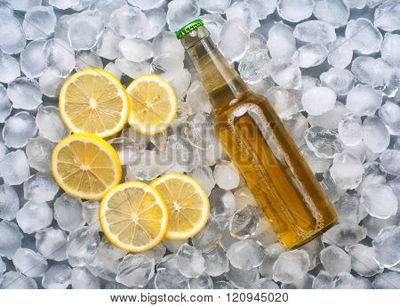 lager bottle with lemon slices in the ice