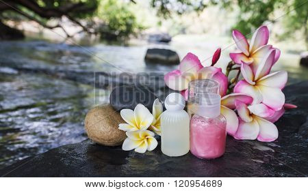 Mini Set Of Bubble Bath Shower Gel Liquid With Flowers And Pebble On Waterfall Rock