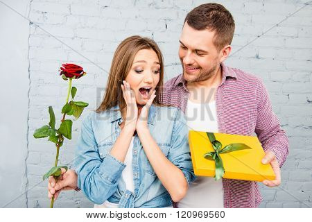 Smiling Man And Happy Surprised Woman With Rose And Gift