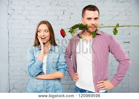 Portrait Of Handsome Man Holding Rose In Mouth For His Girlfriend