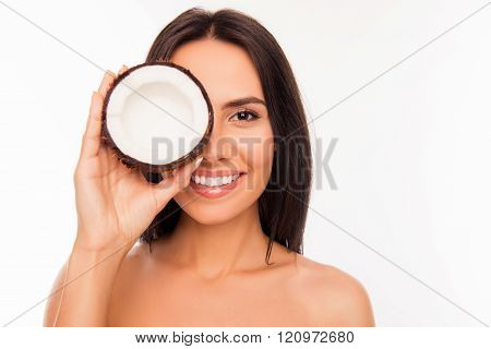 Cheerful Pretty Young Woman Holdind Coconut Near Her Eyes
