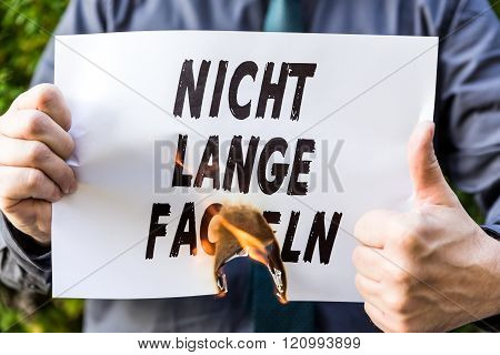 Businessman Is Holding A Burning Paper With Text