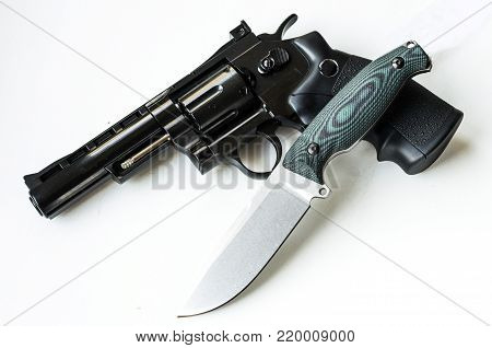 Hunting knife and revolver. Weapons of the military. View from above.