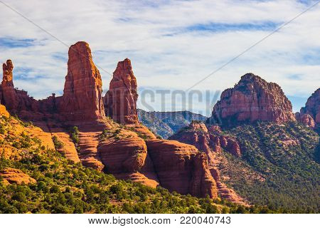 Two Red Rock Formations Jutting Up In Arizona Mountains