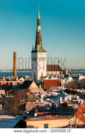 Tallinn, Estonia. Church Of St. Olaf Or Olav And Roofs Of Other Houses In Winter Sunny Day. Popular Destination Scenic