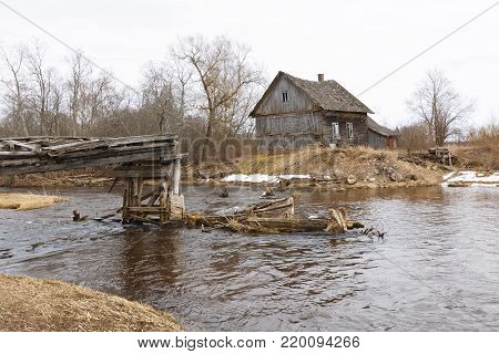 Old collapsed watermills near the river in the early spring.