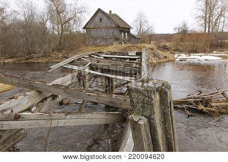 Old collapsed watermills near the river in the early spring.