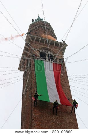 Vicenza, Italy - December 4, 2015:  Firefighter Unroll Italian Flag On The Ancient Tower Called Torr