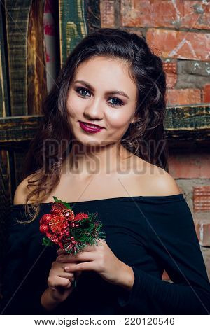 portrait of beautiful brunette woman holding in her hands bouquet of wild flowers. Enjoying sun. Happiness and love concept. Beautiful flowers. Romantic mood. Sunny day on the nature