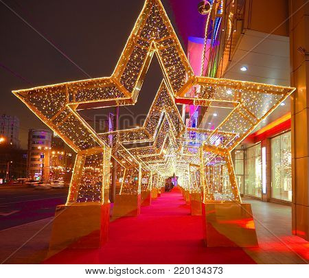 MOSCOW, RUSSIA - DECEMBER  2017:  New Year 2018 and Christmas  New Year's decoration of a street in the form of a tunnel of stars in Moscow