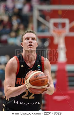 ST. PETERSBURG, RUSSIA - AUGUST 6, 2017: Dmitry Kulagin, Russia performs free throw during basketball match Russia (black) vs Israel (white) during Kondrashin-Belov Cup. Israel won 79-71