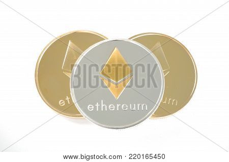 Three real coins of cryptocurrency Silver and golden Ethereum isolated on white background