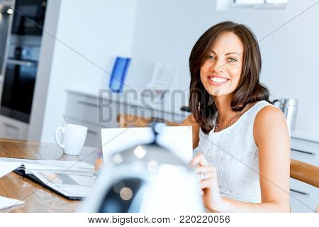 Woman with papers in their living room