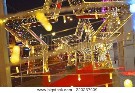 MOSCOW, RUSSIA - DECEMBER  2017:  New Year 2018 and Christmas  New Year's decoration of a street in the form of a tunnel of stars in Moscow