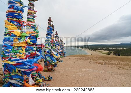 Wooden Ritual Pillars With Colorful Ribbons Hadak On Cape Burkhan. Lake Baikal. Olkhon Island. Russi
