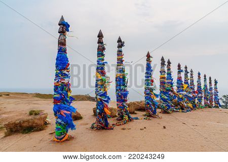 Wooden Ritual Pillars With Colorful Ribbons Hadak On Cape Burkhan. Lake Baikal. Olkhon Island. Russi
