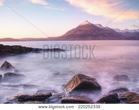 Rocks near Elgol,  Loch Scavaig,  Isle of Skye Scotland. Warm sunset colors in cold February evening. Popular photographers destination.