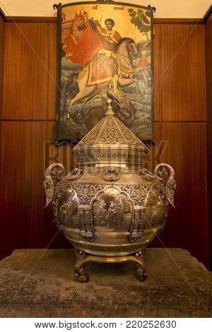 Echmiadzin, Vagharshapat, Armenia, 17 September 2017: Metal vessel with a bas-relief of the baptism of Jesus in the collections of the cathedral in Echmiadzin in Armenia.