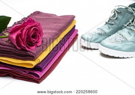 Stylish female sneakers shoes, tippet scarf and rose flower isolated on white background.