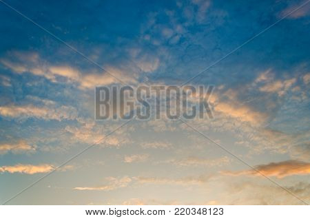 There is a golden light below the horizon. dramatic sky with cloud at sunset,in the morning