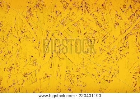 Yellow textured table from wooden chips for background.