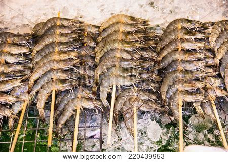  Fresh delicious prawns on ice  in a public street restaurant at Phuket, Thailand.