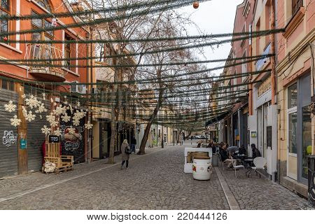PLOVDIV, BULGARIA - DECEMBER 30, 2016:  Walking people and Street in district Kapana, city of Plovdiv, Bulgaria