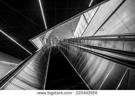 Moving Up Modern Escalator With Yellow Line
