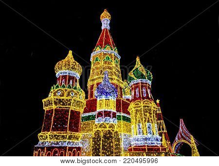Bright lights decoration in form of Saint Basil's Cathedral (Sobor Vasiliya Blazhennogo, Cathedral of Vasily the Blessed) in evening Moscow, Russia