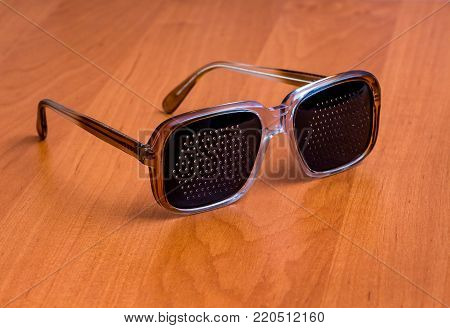 black plastic goggles lying on a brown table