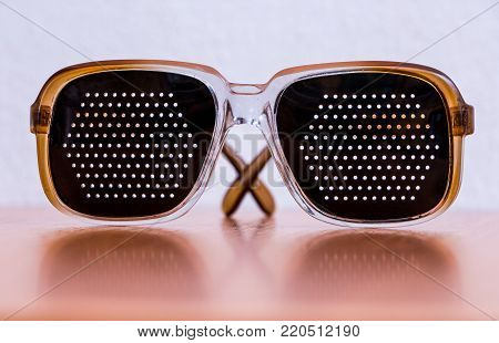 black plastic goggles lying on a brown table