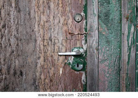 Old door with peeling paint, rust