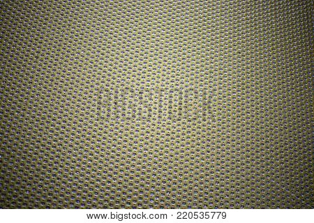 Gold place mat with small circular spots of sparkling blue.