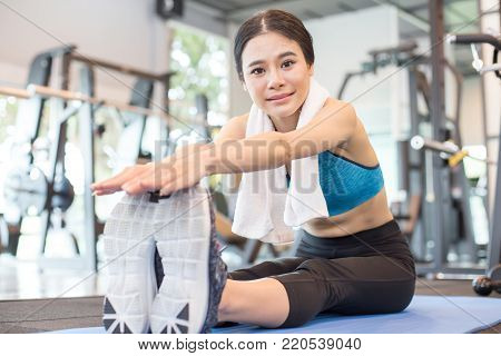 Portrait Of Attractive Young Asian Woman Worm Up Before Exercise At Fitness Club.