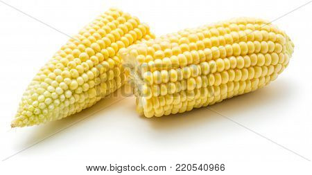 Broken sweet corn halves isolated on white background