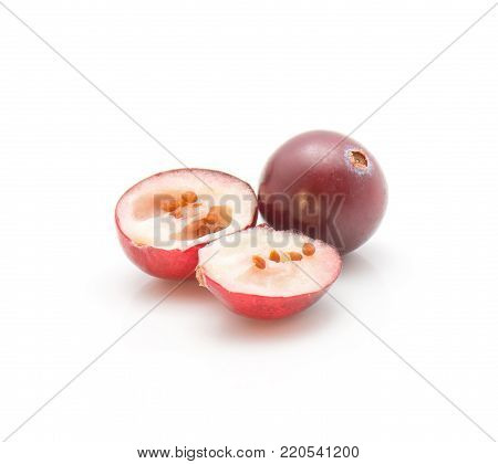 Sliced cranberry close-up isolated on white background one whole and two halves