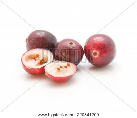 Sliced cranberry close-up isolated on white background three whole and one cut in half