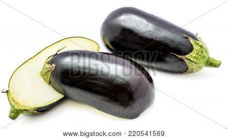 One whole and two halves eggplant (aubergine), longitudinal section, isolated on white background