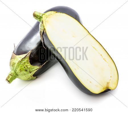 One whole and half eggplant (aubergine), longitudinal section, isolated on white background