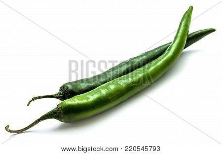 Two whole Chili peppers, green Cayenne, isolated on white background